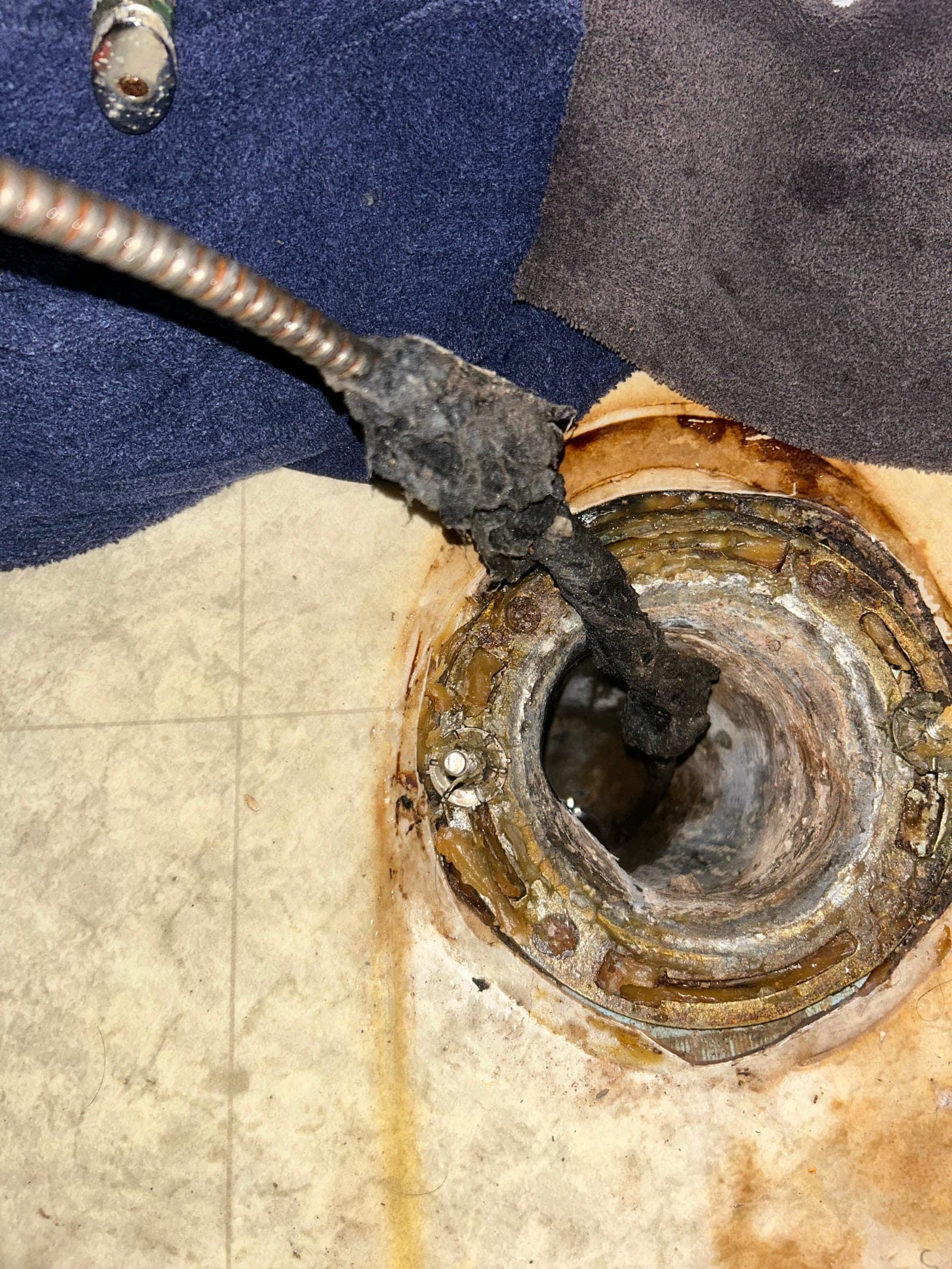 Clearing a clogged drain line with a drain snake