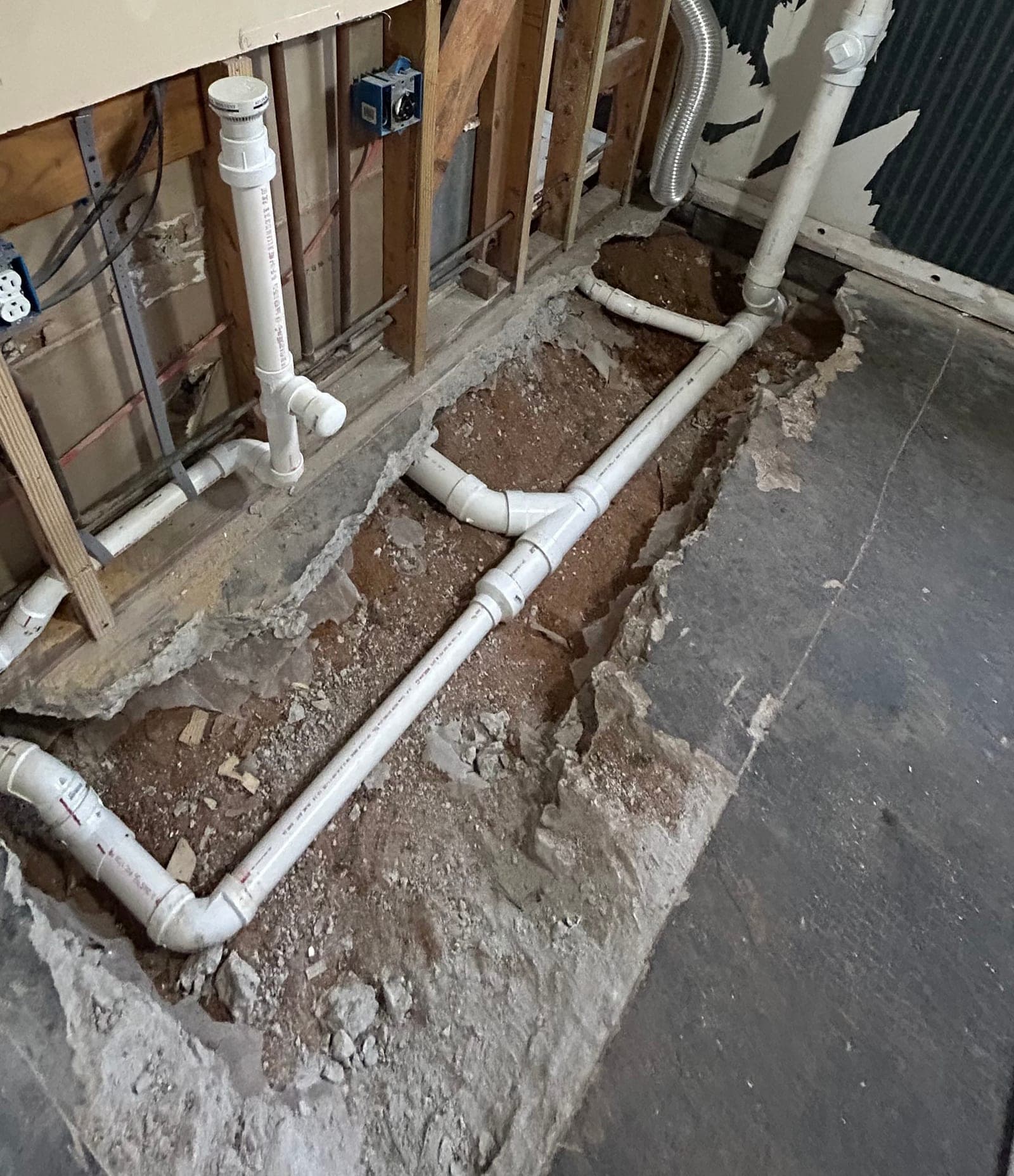 Underground repiping trench with new PVC line