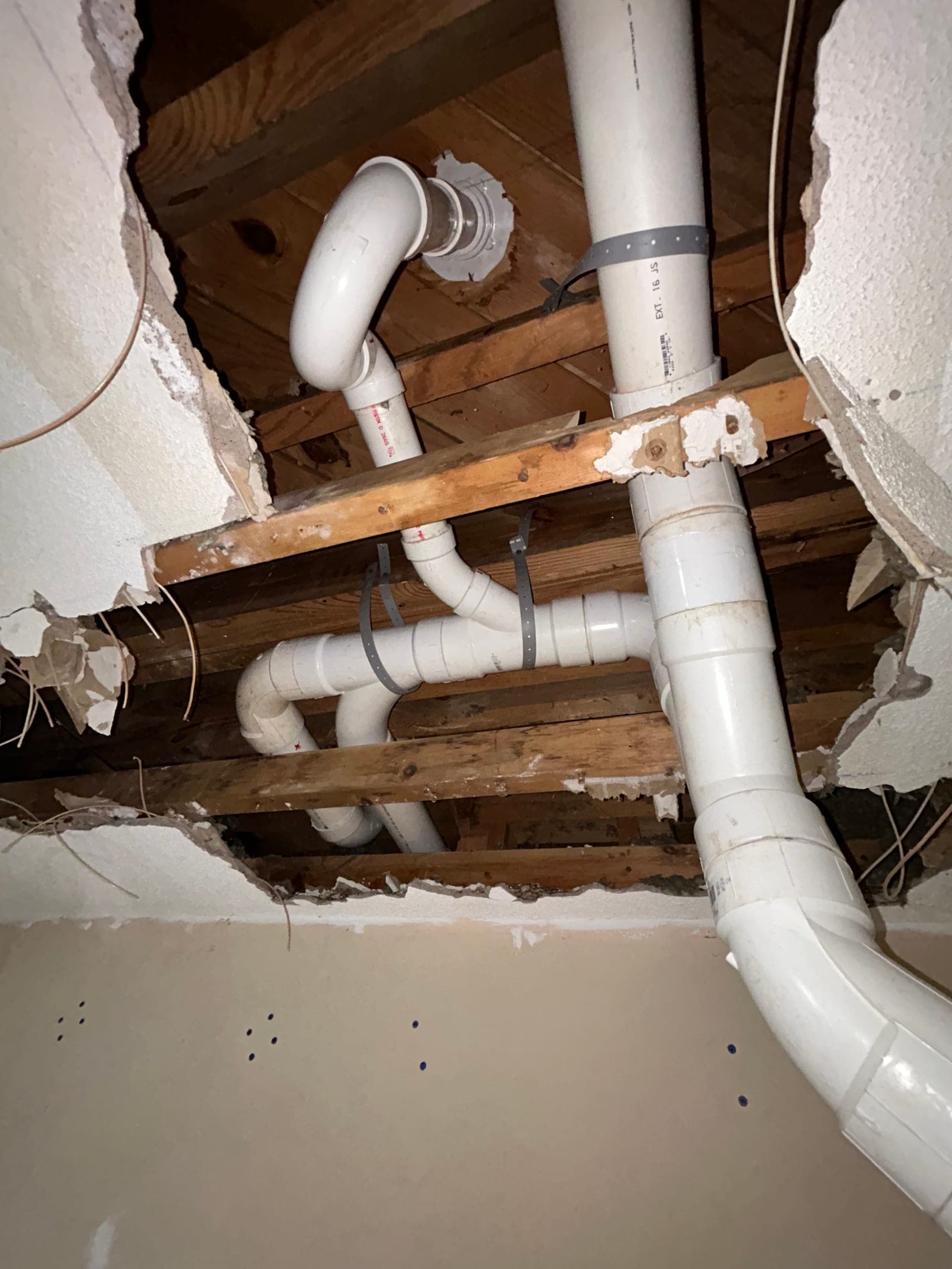 Exposed bathroom wall plumbing during a remodel